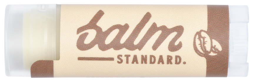 Balm Standard lip balm packaging with a beige and brown design.