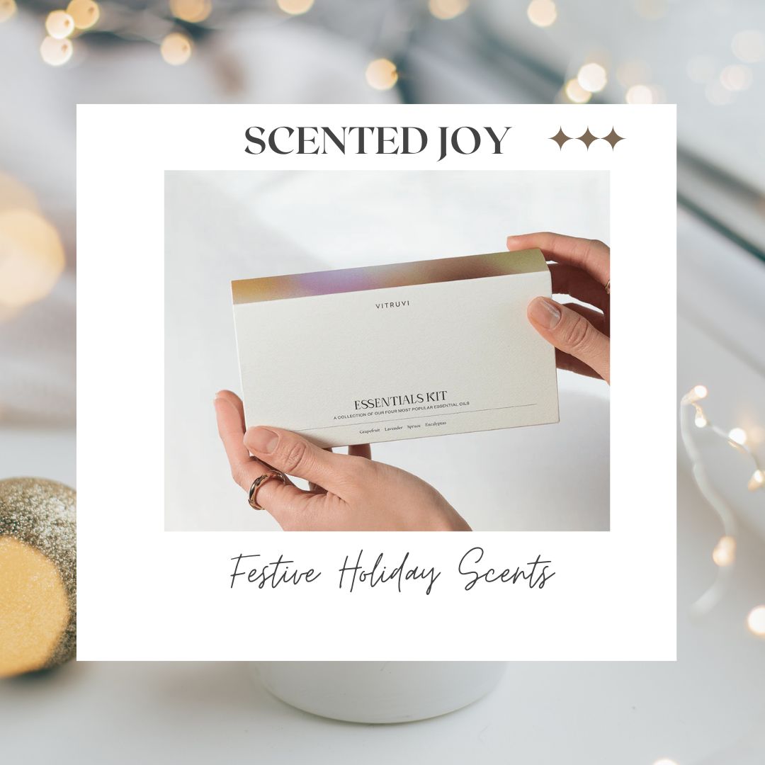 festive holiday background with hands holding box of four kit of essential oils.