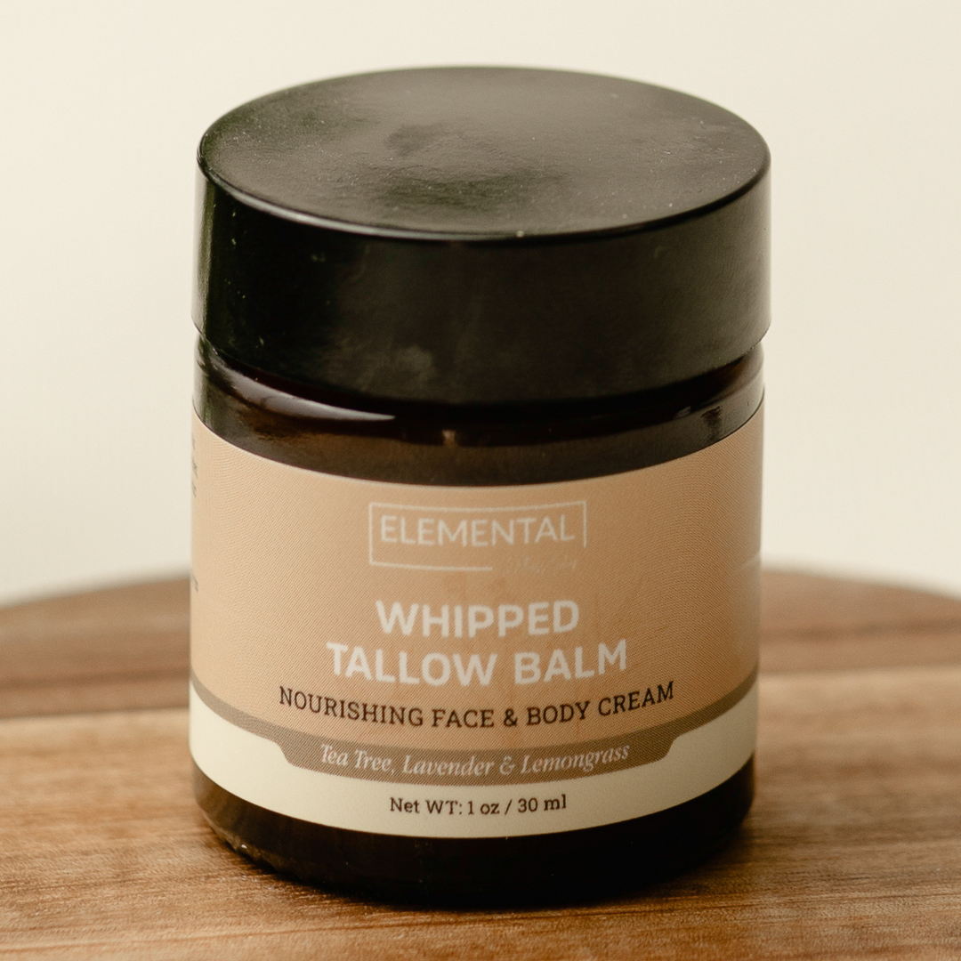 Whipped tallow balm jar labeled 'Elemental' on a wooden surface