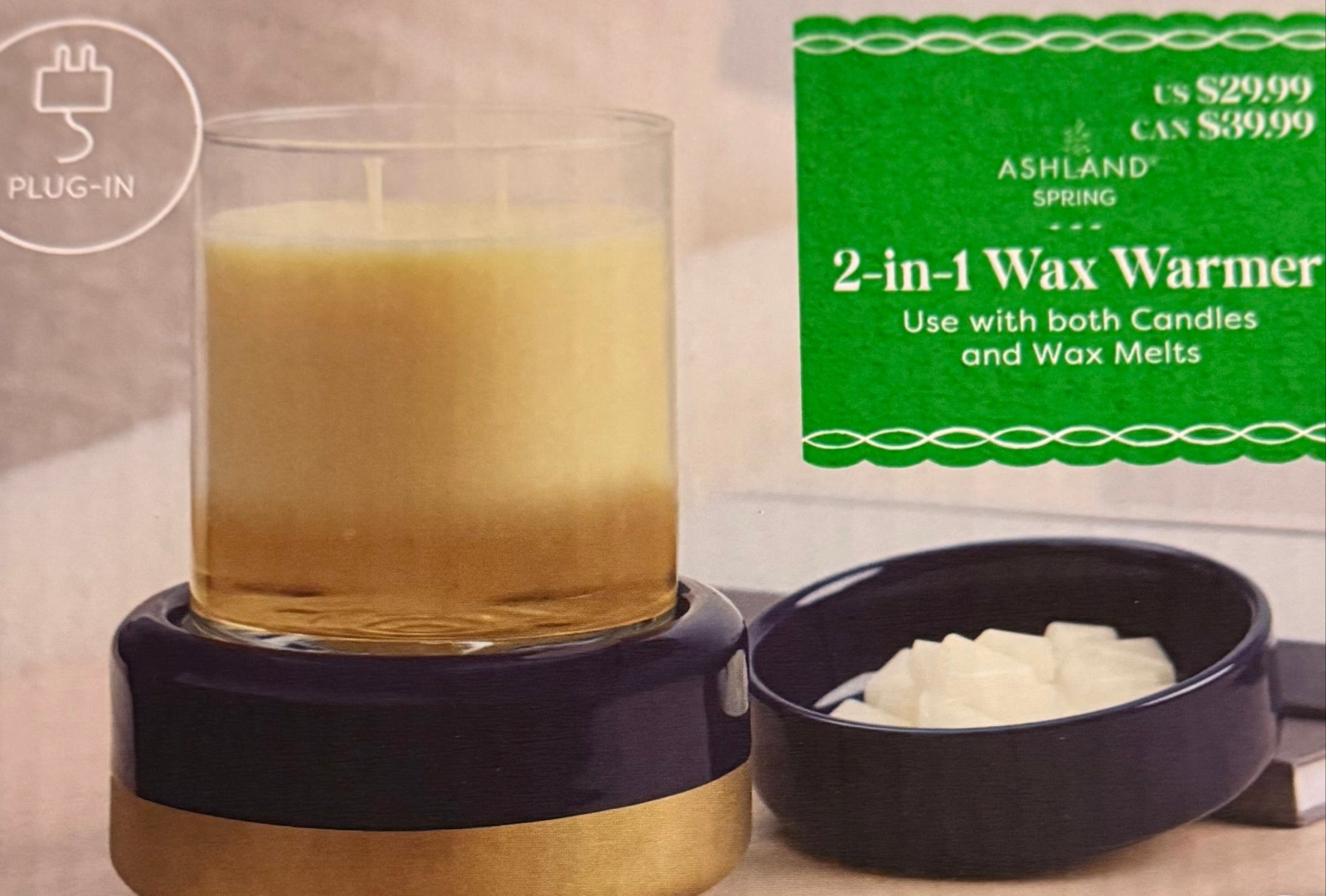Candle in a wax warmer with an Ashland  2-in-1 Wax Warmer packaging in the background.