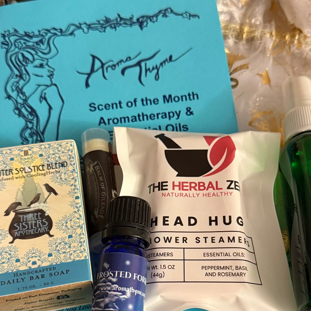 Scent of the Month Club Collection of Aroma Thyme and The Herbal Zen products including a bottle, soap, and steamers.