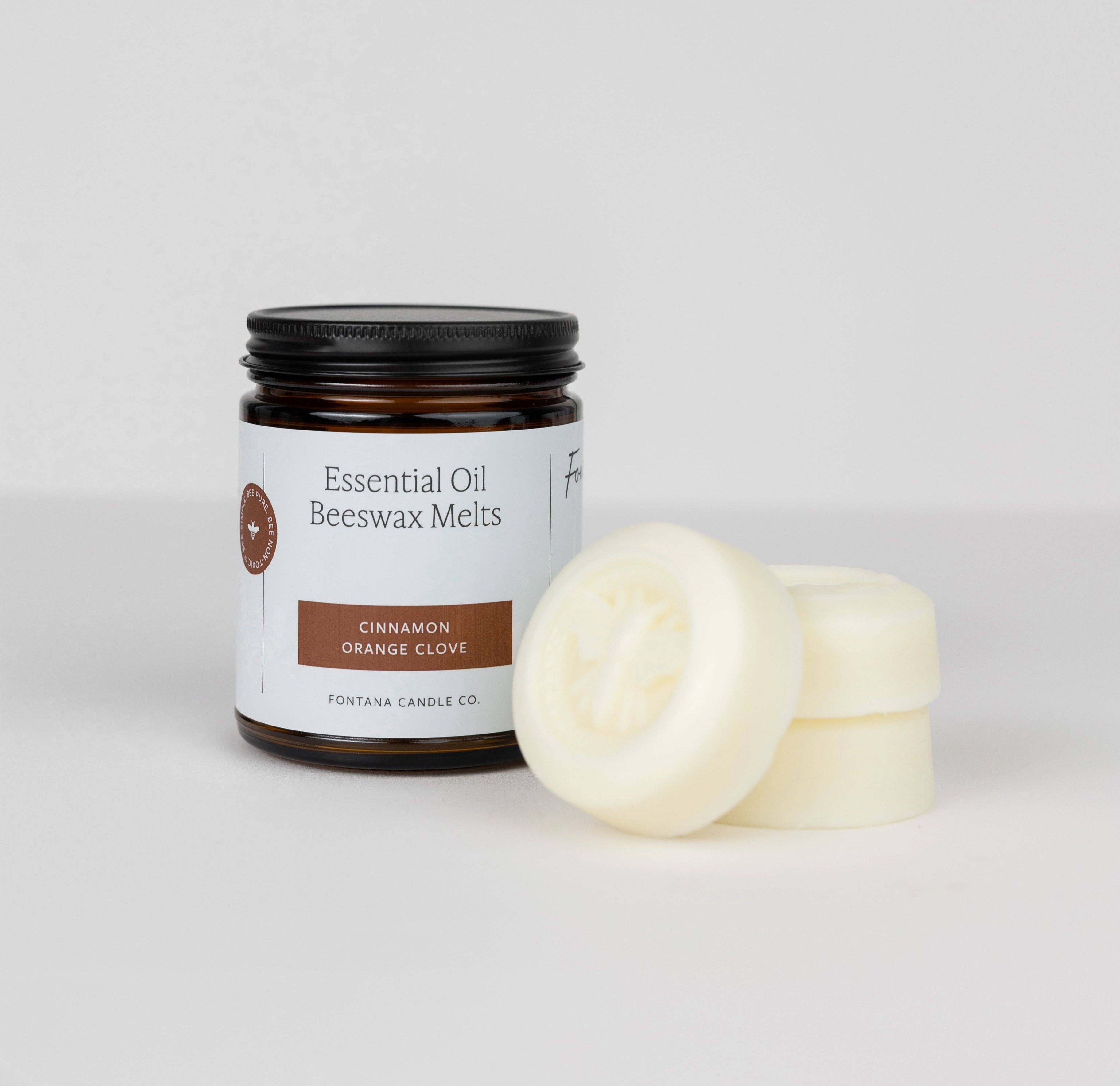 Jar of essential oil beeswax melts with three melts on a white background